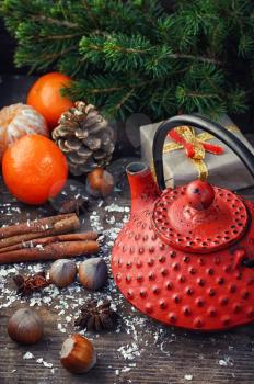 Branch of pine,tangerines,cinnamon on background of Christmas decorations