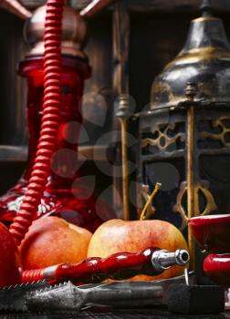 Smoking hookah tobacco with apple aroma and stylish Arabic lantern