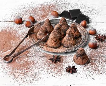 Chocolate truffles candies with cocoa powder and nuts