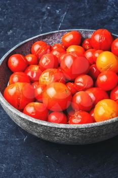 Salt little tomatoes from the fall harvest in stylish bowl