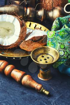 Stylish oriental shisha and ripe tropical coconut