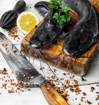 raw fish catfish on the kitchen board