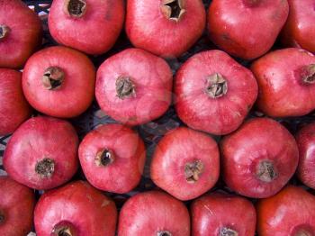 A pile of beautiful  pomegranates on a counter