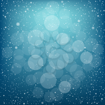Winter blue bokeh background with snow. Christmas and New Year backdrop