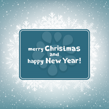 The colored blue rectangular paper with the message of Christmas greetings on light snow background