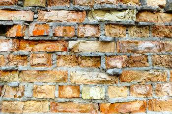 Old destroyed red brick wall background texture. Broken building stone construction