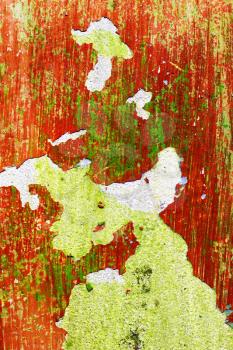 Green and red vertical wall before repair. Rough housework wallpaper design backdrop. Color room interior decoration texture template background