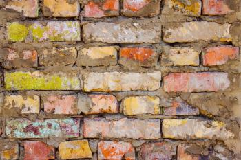 Old colored brick wall background. Retro architecture texture backdrop. Vintage exterior wallpaper