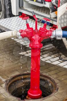 Fire truck equipment. Hoses supply connected to hydrant and well