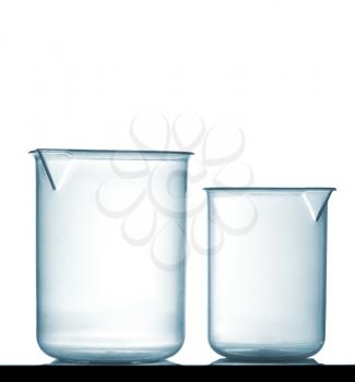 Isolated chemical plastic beakers on table with a small reflection, studio shot