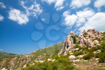 Natural landscape of Corsica island, mountains under dramatic cloudy sky