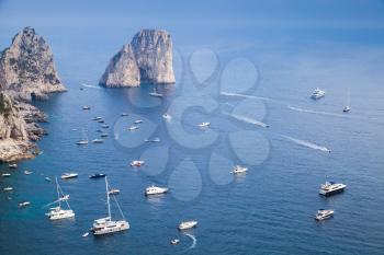 Capri island, Italy. Coastal landscape with Faraglioni rocks and pleasure yachts