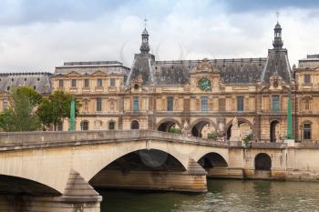 PARIS, FRANCE - AUGUST 07, 2014: The New Bridge on Seine river with Louvre museum facade on other side