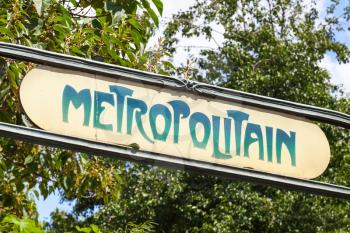 Art-Deco styled Street sign at the entrance to the Paris Metro