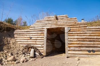 Wooden wall and open door of traditional underground sauna in Finland
