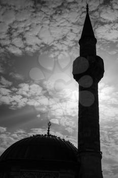 Minaret of ancient Camii mosque on Konak square, Izmir, Turkey. Black and white silhouette photo
