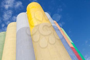 Abstract industrial architecture fragment, large colorful concrete tanks for storage of bulk materials