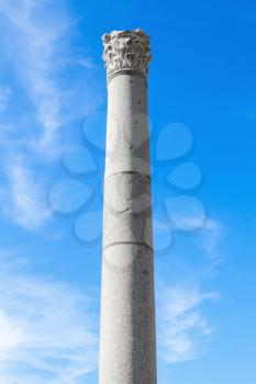 Ancient column on blue sky background, fragment of ruined roman temple in Smyrna. Izmir, Turkey