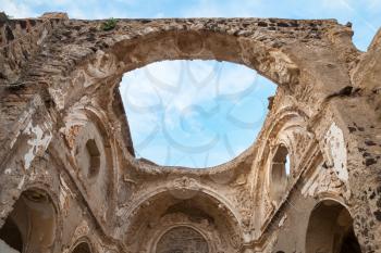 Ruined church interior without roof under blue cloudy sky, Ischia Porto, Bay of Naples, Italy