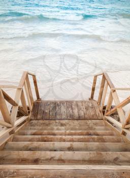 Empty wooden stairs goes down to the sea
