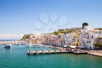 Small Italian coastal town cityscape with colorful houses and piers. Port of Procida island, Gulf of Naples, Italy