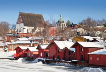 Red wooden houses on the river coast in Porvoo town, Finland (winter season)