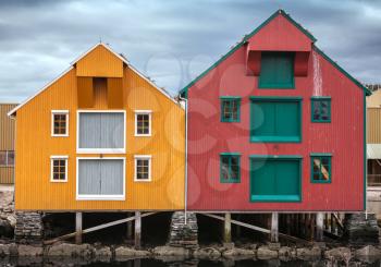 Red and yellow coastal wooden houses in Norway