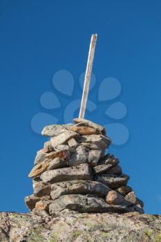 Stone cairn as a navigation mark on the top of Norwegian mountain