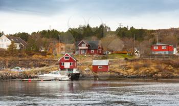 Traditional Norwegian fishing village with wooden houses on seacoast