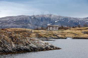 Old abandoned gray wooden house on the seacoast in Norway
