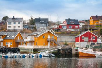 Norwegian fishing village, wooden houses on the sea coast and moored boats