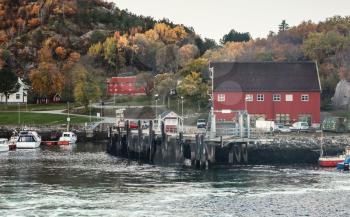 Norwegian fishing village on the sea coast. Wooden houses and moored boats. Hasselvika is a village in the municipality of Rissa in Sor-Trondelag county, Norway