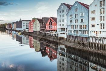 Wooden living houses along the river coast. Trondheim, Norway. Cold tonal correction photo filer