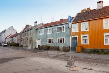 Scandinavian wooden houses stand along old street in Trondheim, Norway