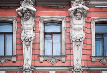 Facade with men statues of an old palace in St.Petersburg, Russia. Belosselsky-Belozersky Palace is Neo-Baroque style was built in 1847-48 by project of Andrei Ivanovich Stakenschneider