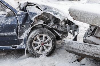 Crashed cars in accident on winter road with snow