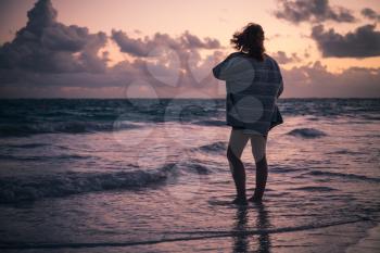 Silhouette of girl walking on the beach in early morning. Dominican Republic, Punta Cana