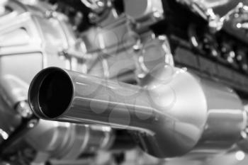 Exhaust and motor parts, sport car V12 engine fragment, closeup photo with selective focus