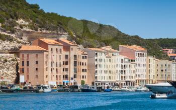 Pleasure boats are moored near embankment of Bonifacio, small resort port city of Corsica island