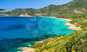 Coastal landscape of South Corsica. Small azure bay with sailing yachts, Piana, France