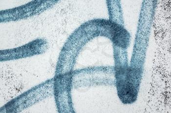 Abstract blue urban graffiti fragment over old white concrete wall