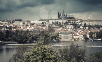 Panoramic view of Old Prague with St. Vitus Cathedral and Charles Bridge. Stylized photo with vintage tonal correction effect
