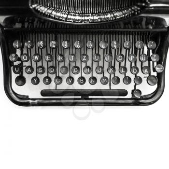 Old manual typewriter machine, fragment with keyboard over white background, square black and white photo with soft selective focus