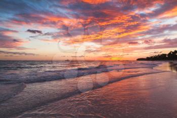 Colorful clouds in sunrise over Atlantic Ocean coast, Bavaro beach, Hispaniola Island. Dominican Republic, coastal landscape
