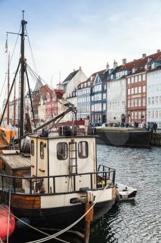 Ships moored in Nyhavn, 17th-century waterfront, canal and popular touristic district in Copenhagen, Denmark