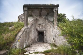Entrance in abandoned concrete bunker from WWII period on Totleben fort island in Gulf of Finland near Saint-Petersburg in Russia