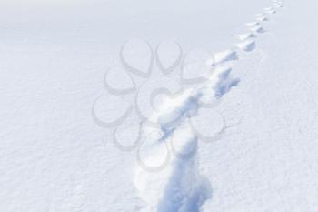 Footprints in deep snowdrift, natural winter background photo