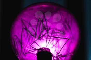 Decorative purple tungsten lamp fragment, close-up photo with selective focus and shallow DOF