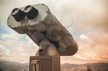Paid binocular telescope, closeup photo over cloudy sky in evening