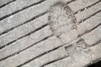 Human footprint in concrete ground, close up photo texture